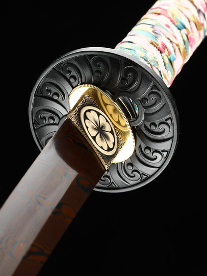 The hand-forged blade is crafted from pattern-welded steel, hammered and forged through countless strikes