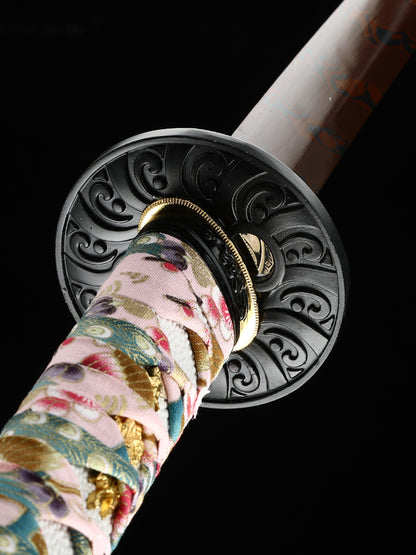 The hand-forged blade is crafted from pattern-welded steel, hammered and forged through countless strikes