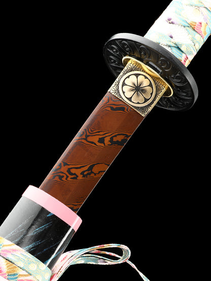The hand-forged blade is crafted from pattern-welded steel, hammered and forged through countless strikes