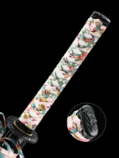 The hand-forged blade is crafted from pattern-welded steel, hammered and forged through countless strikes
