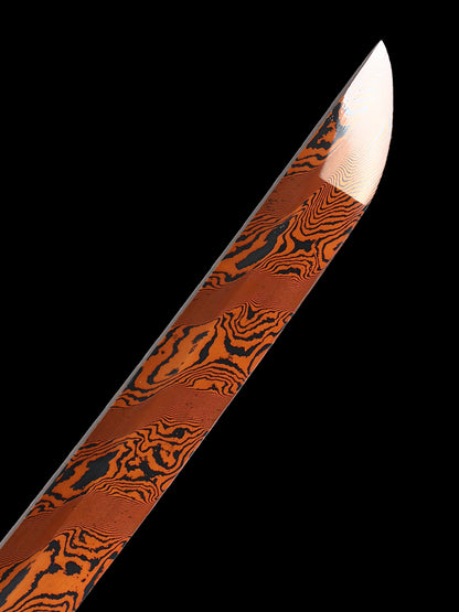 The hand-forged blade is crafted from pattern-welded steel, hammered and forged through countless strikes